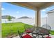 Relaxing patio with outdoor seating and a view of the green backyard and white fence at 5808 Arboretum St, St Cloud, FL 34771