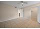 This bedroom features tile flooring, a ceiling fan, and a closet for comfortable living at 614 Orange Dr # 196, Altamonte Springs, FL 32701