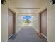 Well-lit condo entryway with doors leading to individual units and views of outdoor area at 614 Orange Dr # 196, Altamonte Springs, FL 32701