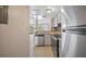 Updated kitchen with stainless steel appliances and view of living area at 614 Orange Dr # 196, Altamonte Springs, FL 32701