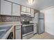 Updated kitchen features stainless steel appliances, ample counter space, and tile floors at 614 Orange Dr # 196, Altamonte Springs, FL 32701