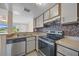 Updated kitchen with stainless steel appliances and tile backsplash at 614 Orange Dr # 196, Altamonte Springs, FL 32701