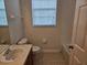 Bathroom view includes a vanity, toilet, mirror and a shower-tub combo at 6214 Stevenson Dr # 208, Orlando, FL 32835