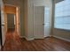 Bedroom featuring an open closet, natural lighting, and hardwood floors at 6214 Stevenson Dr # 208, Orlando, FL 32835