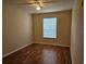Bedroom boasts hardwood floors, a ceiling fan, and a bright window at 6214 Stevenson Dr # 208, Orlando, FL 32835