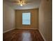 Bedroom boasts hardwood floors, a ceiling fan, and a bright window at 6214 Stevenson Dr # 208, Orlando, FL 32835