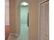 Hallway features neutral paint, tile flooring, and a partial kitchen view at 6214 Stevenson Dr # 208, Orlando, FL 32835