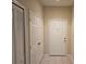 Hallway view features neutral walls, multiple doors and tile flooring at 6214 Stevenson Dr # 208, Orlando, FL 32835