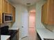 Galley kitchen with stainless steel appliances, light countertops, and wood cabinets at 6214 Stevenson Dr # 208, Orlando, FL 32835