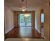Bright living room with wood flooring, ceiling fan, and sliding glass doors leading to a balcony at 6214 Stevenson Dr # 208, Orlando, FL 32835
