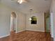 Spacious living room with arched doorways, wood floors, and a view to the kitchen at 6214 Stevenson Dr # 208, Orlando, FL 32835
