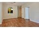 Inviting living room featuring hardwood floors, a view of the kitchen, and neutral wall colors at 6214 Stevenson Dr # 208, Orlando, FL 32835