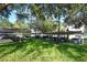 Carport with multiple parking spaces, surrounded by green lawn and trees at 6214 Stevenson Dr # 208, Orlando, FL 32835