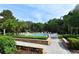 Resort-style pool area with lush landscaping, patio, and comfortable lounge seating at 6214 Stevenson Dr # 208, Orlando, FL 32835