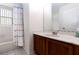 Cozy bathroom featuring a shower/tub combo with a bright patterned curtain and vanity at 630 Park Valley Cir, Minneola, FL 34715