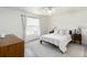 Bright bedroom featuring a bed, white linens, neutral rug, and natural light from the window at 630 Park Valley Cir, Minneola, FL 34715