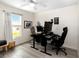 Bright office/bedroom featuring two workstations, natural light, and wood-look flooring at 630 Park Valley Cir, Minneola, FL 34715