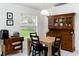 Inviting dining room with a wooden table, black chairs, and a traditional china cabinet at 630 Park Valley Cir, Minneola, FL 34715