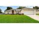 Charming single-story home with well-maintained lawn and inviting front entrance, and two-car garage at 630 Park Valley Cir, Minneola, FL 34715