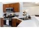Well-equipped kitchen with stainless steel appliances, modern countertops, and ample cabinet space, perfect for cooking at 630 Park Valley Cir, Minneola, FL 34715