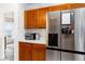 Bright kitchen featuring wooden cabinetry, white countertops, and stainless steel appliances at 630 Park Valley Cir, Minneola, FL 34715