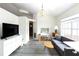 Open-concept living area with sleek flooring, plenty of natural light, and a modern, neutral color palette at 630 Park Valley Cir, Minneola, FL 34715