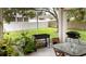 Covered patio area with barbecue, table, and chairs, perfect for outdoor entertaining and relaxing at 630 Park Valley Cir, Minneola, FL 34715