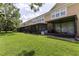 View of condo backyard featuring lush green grass and private screened lanais at 6388 Castelven Dr # 102, Orlando, FL 32835