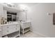 Bathroom featuring dual sinks, a large mirror, and a shower with dark accent tiles at 6388 Castelven Dr # 102, Orlando, FL 32835