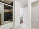 Bathroom featuring a black tiled shower and view into the bright primary bedroom at 6388 Castelven Dr # 102, Orlando, FL 32835
