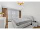 Bedroom with neutral tones, large window, modern lighting, and soft textures throughout at 6388 Castelven Dr # 102, Orlando, FL 32835