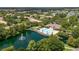An aerial view of the community pool with a lake, mature landscaping and a water fountain at 6388 Castelven Dr # 102, Orlando, FL 32835