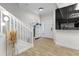 Bright entryway with wood-look tile flooring, staircase, decorative mirror, and modern accents at 6388 Castelven Dr # 102, Orlando, FL 32835