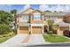 Inviting townhouse featuring a well-manicured lawn and private garages at 6388 Castelven Dr # 102, Orlando, FL 32835