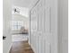 Hallway with closet space leading to a brightly lit office with a ceiling fan at 6388 Castelven Dr # 102, Orlando, FL 32835