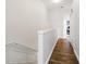 Hallway featuring hardwood floors, white walls and trim, with doorway view into office at 6388 Castelven Dr # 102, Orlando, FL 32835