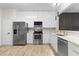 Well-equipped kitchen featuring modern appliances, stone countertops, and white cabinetry at 6388 Castelven Dr # 102, Orlando, FL 32835