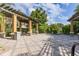 Community pergola space with outdoor seating, brick pavers, and lush landscaping at 6388 Castelven Dr # 102, Orlando, FL 32835