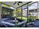 Cozy screened patio featuring comfortable seating, lush greenery, and outdoor living space at 6388 Castelven Dr # 102, Orlando, FL 32835
