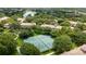 Aerial view of the community featuring tennis courts surrounded by lush landscaping at 6388 Castelven Dr # 102, Orlando, FL 32835