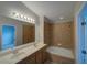 Bathroom with double sink vanity and tiled tub-shower combination at 7462 Bentonshire Ave, Windermere, FL 34786