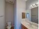 Compact bathroom with toilet, vanity and mirrored medicine cabinet at 7462 Bentonshire Ave, Windermere, FL 34786