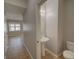 Cozy bathroom with pedestal sink and toilet in neutral tones enhances functionality and design at 7462 Bentonshire Ave, Windermere, FL 34786
