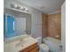Bright bathroom with a vanity, mirror, and tiled shower-tub combo at 7462 Bentonshire Ave, Windermere, FL 34786