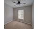 Simple bedroom with a ceiling fan and natural light from a window offers a cozy and calming space at 7462 Bentonshire Ave, Windermere, FL 34786