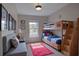 ' bedroom features a wooden bunk bed, sofa, artwork, and a window at 7462 Bentonshire Ave, Windermere, FL 34786