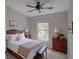 Comfortable bedroom featuring a ceiling fan, large window, and classic furnishings for a welcoming retreat at 7462 Bentonshire Ave, Windermere, FL 34786