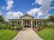 Inviting clubhouse with a well-kept lawn and charming architectural details at 7462 Bentonshire Ave, Windermere, FL 34786