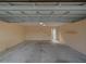Spacious, unfinished garage with painted walls and concrete floor at 7462 Bentonshire Ave, Windermere, FL 34786