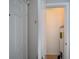 Hallway view with neutral walls leading to a water heater storage area at 7462 Bentonshire Ave, Windermere, FL 34786